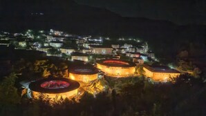 A historic building complex with multiple circular structures, surrounded by residential buildings.