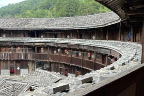 A traditional wooden building with a curved roof and multiple balconies. - Yuqinglou Inn (Longyan)