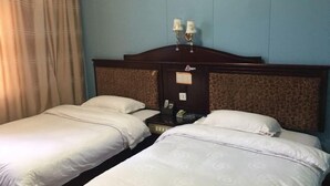 A hotel room with two beds, a nightstand, a lamp, and a window with curtains. - Shuangfeng Century Hotel (Shuangfeng)
