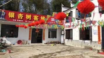 A building with a red sign, possibly a business, and traditional decorations.