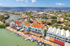 A coastal resort with multiple buildings, a marina, and a view of the ocean.