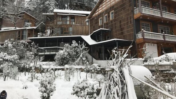 Ein Holzhaus mit mehreren Balkonen und einer überdachten Außenveranda.