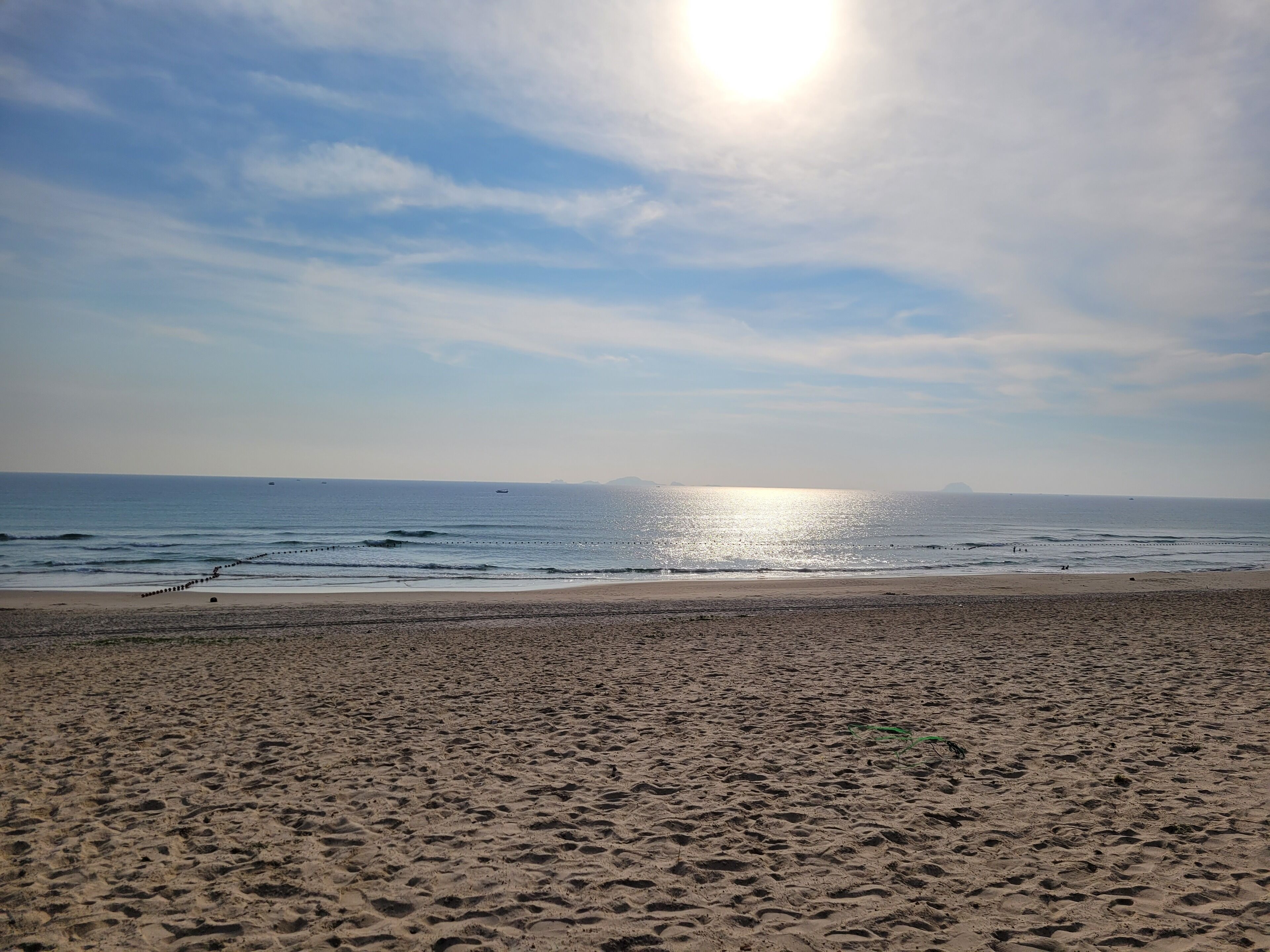 A beach with a clear sky and calm sea.