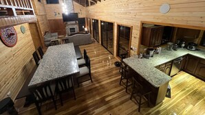 A log cabin interior with a dining area, kitchen, and a fireplace. - Full house with breathtaking views (San José)