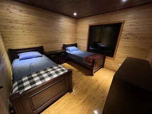 A cabin-style room with two wooden beds, a small desk, and a large window. - Full house with breathtaking views (San José)
