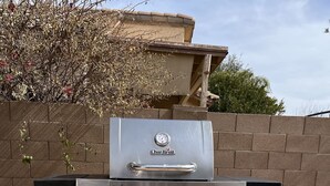 A Char-Broil commercial grill with a digital thermometer, two side burners, and a front grill. - Spacious, Comfortable Home Near Golf, Biking, Hiking & Restaurants (Tucson)