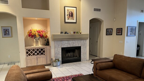 A living room with a fireplace, two sofas, a coffee table, and a patterned rug. - Spacious, Comfortable Home Near Golf, Biking, Hiking & Restaurants (Tucson)