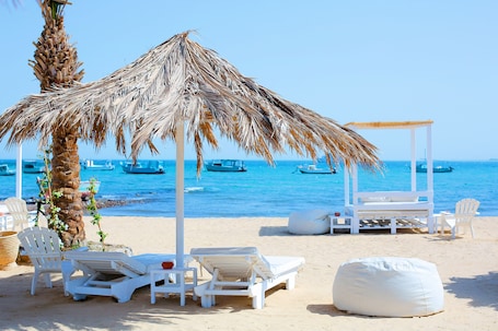 Private beach, beach umbrellas, beach towels, beach bar