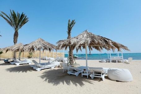 Private beach, beach umbrellas, beach towels, beach bar
