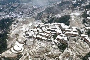 A terraced village with traditional buildings. - Da Tian E Hotel (Longsheng)