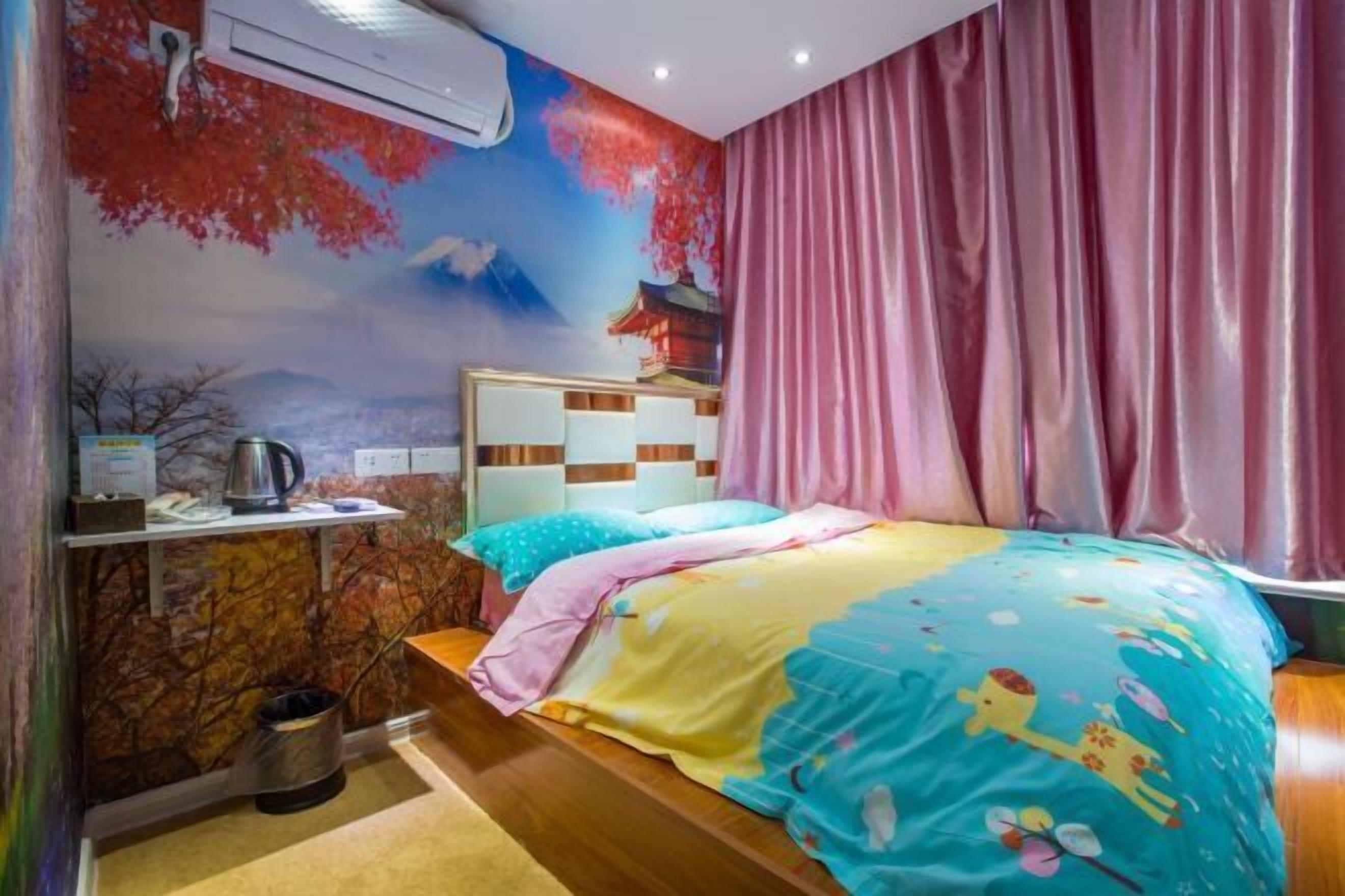 Un dormitorio con cama, mesita de noche, aire acondicionado instalado en la pared y un mural decorativo.