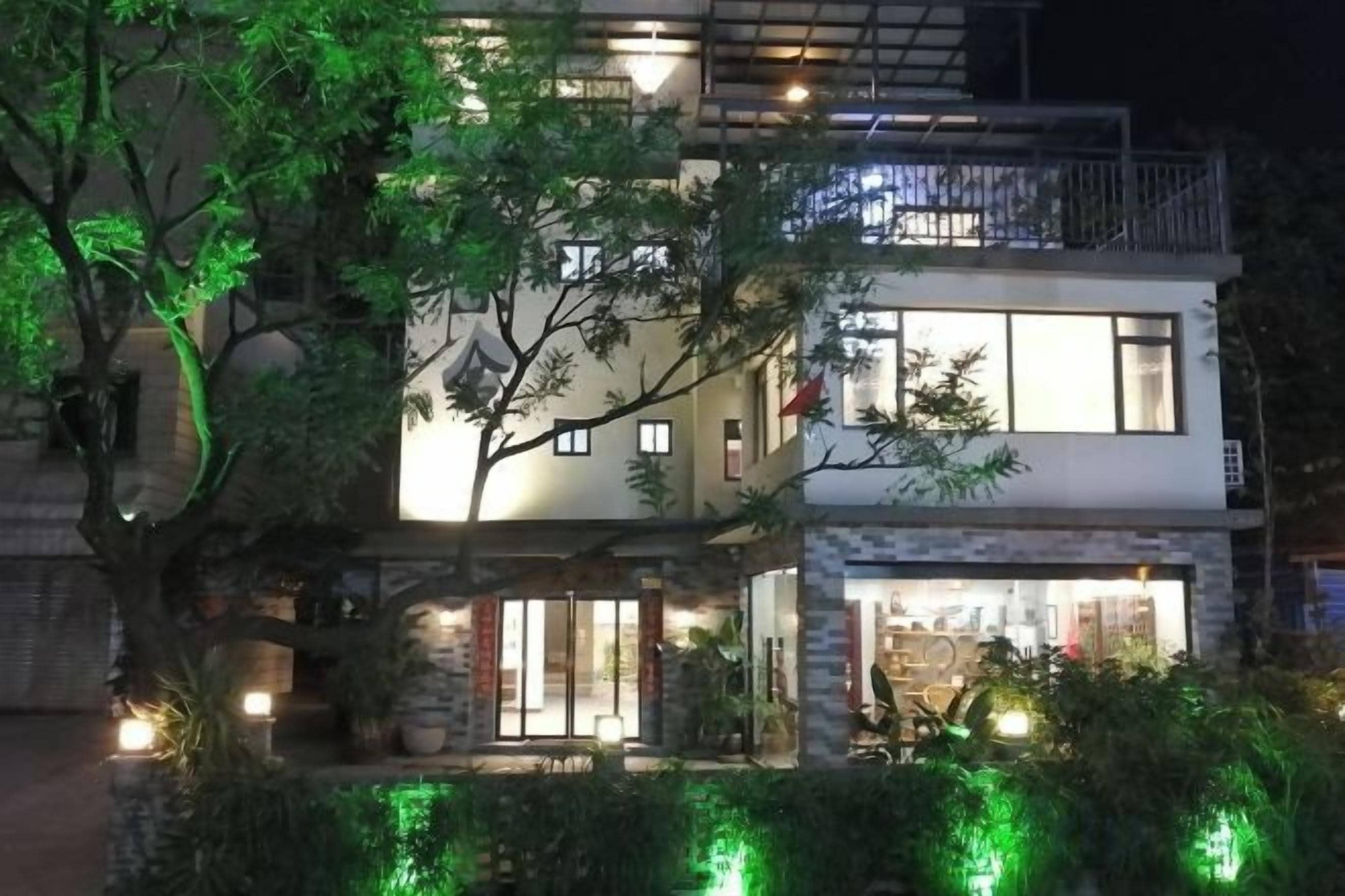 A two-story building with a balcony on the upper level.