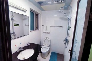 A small bathroom with a white sink, a toilet, and a shower. - Shuijutang Boutique Inn (Wuyuan)