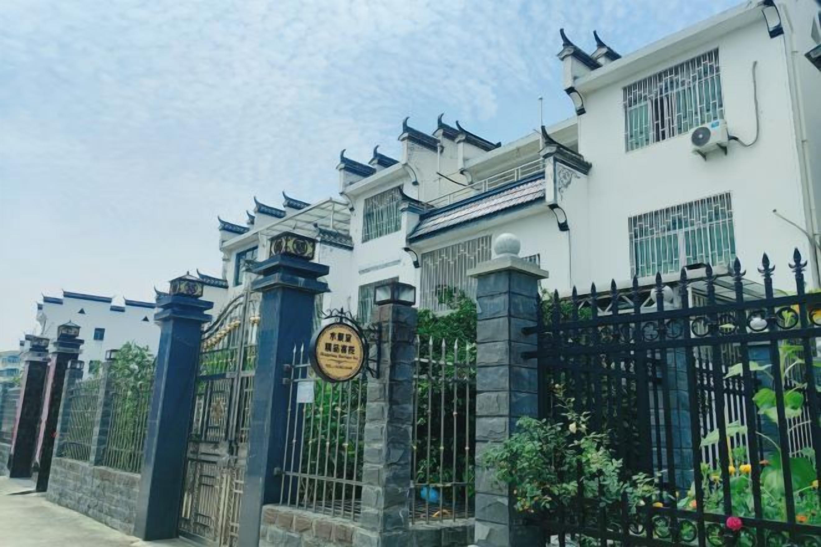 A gated residential area with traditional architectural elements, including tiled roofs and decorative eaves.
