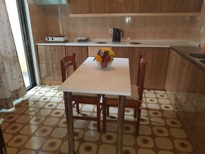 Fridge, stovetop, cookware/dishes/utensils, dining tables