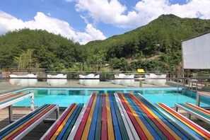 A pool area with lounge chairs and a view of a mountainous landscape. - Youxi Guxi Galaxy Moon Mountain House (Youxi)