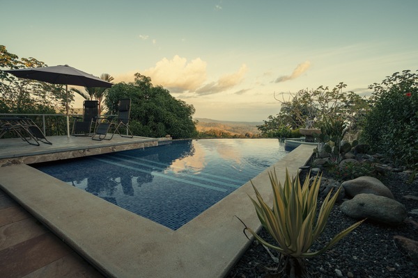 Een buitenzwembad en een infinitypool