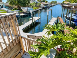 A marina with docked boats, a wooden deck, and a view of the water.