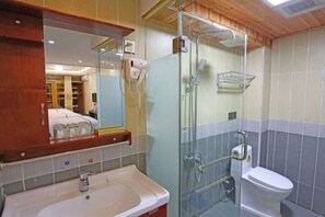 A bathroom with a glass-enclosed shower, a white sink, and a toilet. - Fenghuang Memory River View Inn - Near Ancient City & River View Balcony (Fenghuang County)