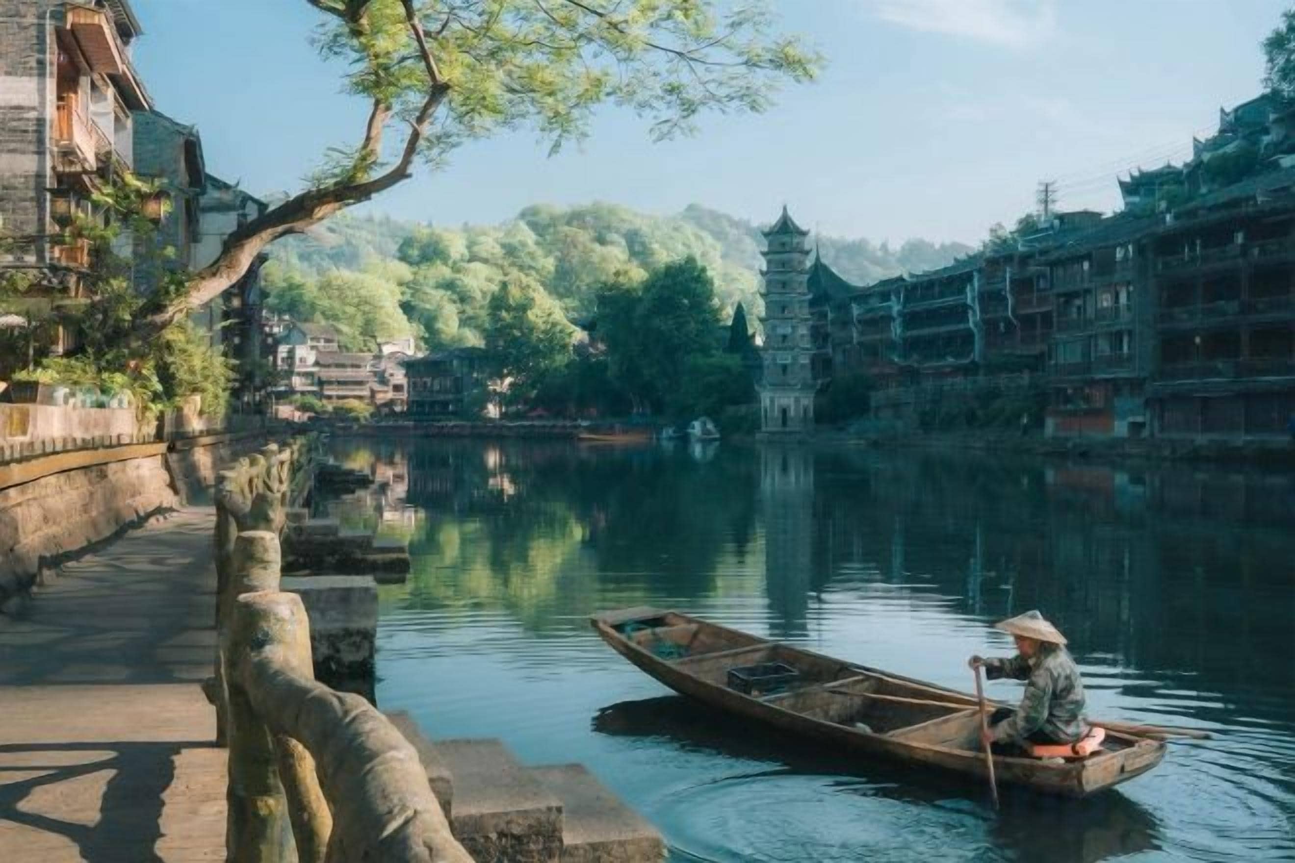 Un edificio tradicional con techo al estilo pagoda, un río tranquilo y una persona en una barca.