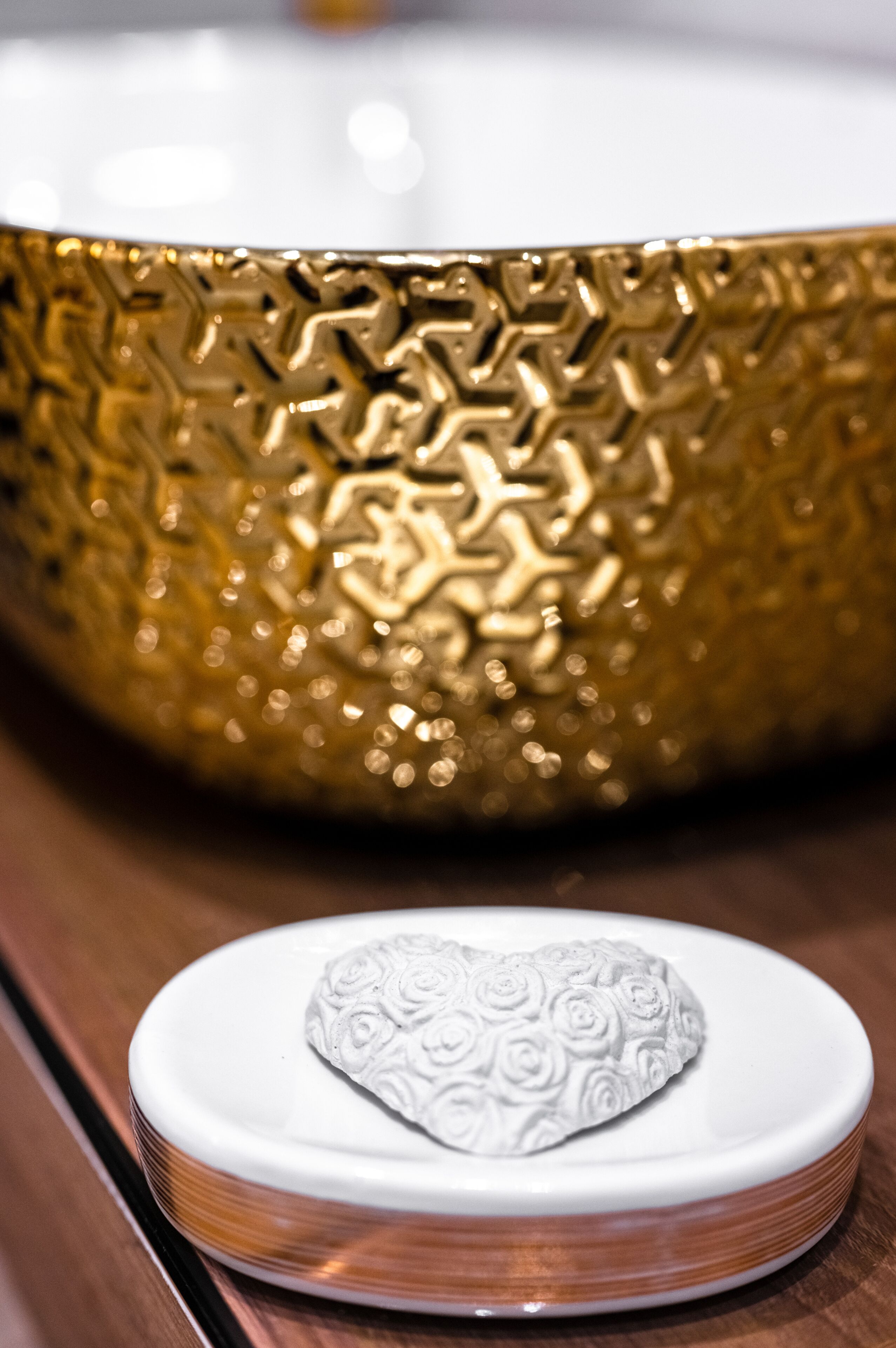 A white ceramic bowl with a floral pattern on a wooden surface.