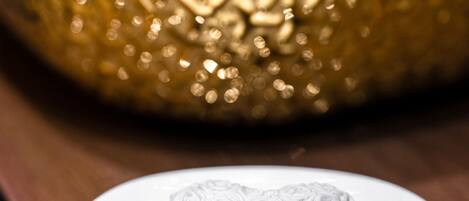 A white ceramic bowl with a floral pattern on a wooden surface.