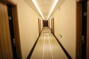 A hotel hallway with doors numbered 516 and 511, leading to rooms. - Shangjia Hotel (Anping)