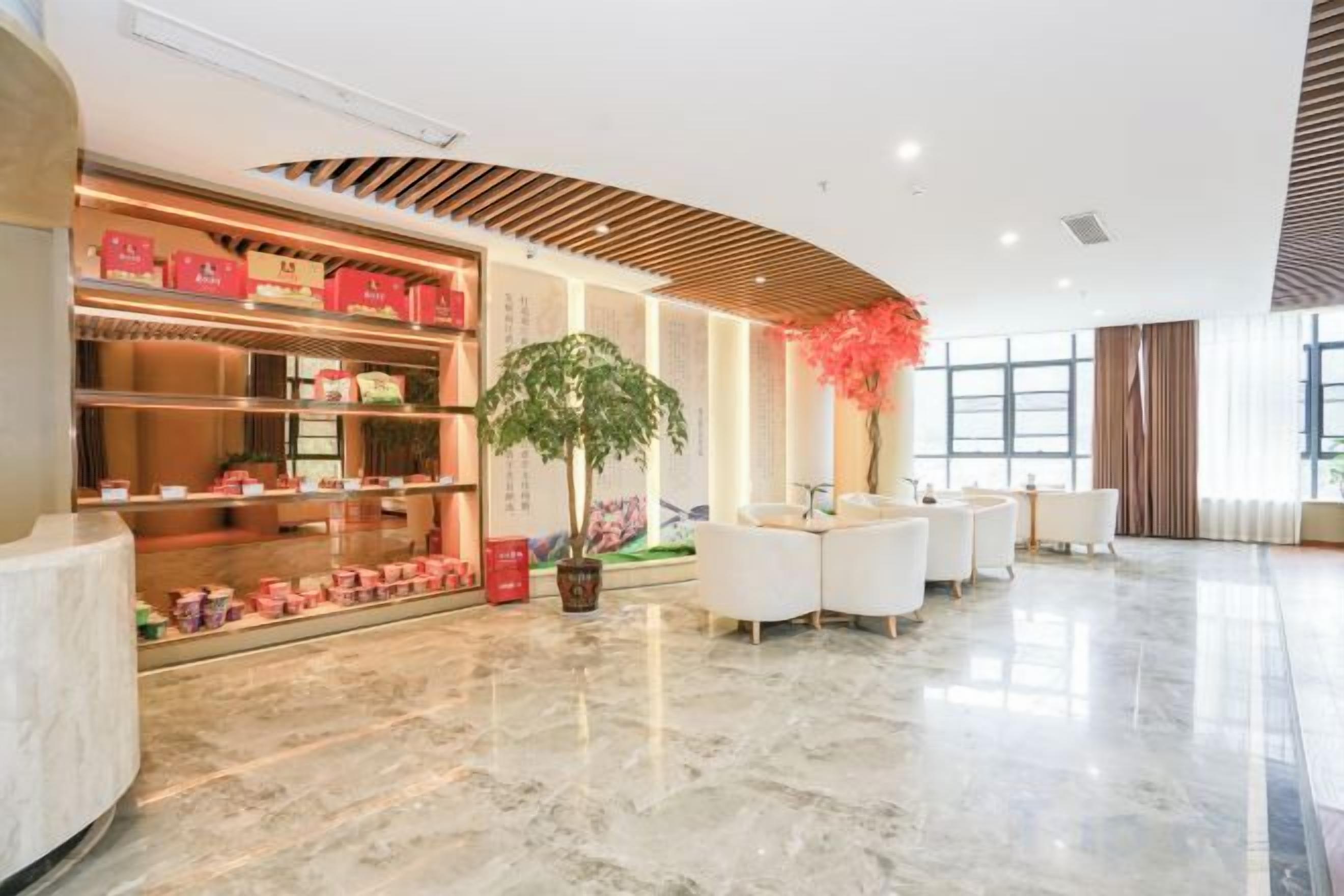 A spacious lobby with a reception desk, seating area, and a display of products.