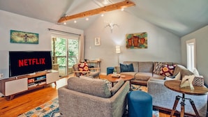 A modern living room with a large flat-screen TV, a sofa, a coffee table, and a TV stand. - Connects to Table Rock/Mountain View/Gigabit Wi-Fi/Covered Parking/Private Trail (Pickens)