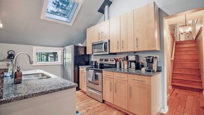 A kitchen with wooden cabinets, a stainless steel oven, a microwave, and a coffee maker. - Connects to Table Rock/Mountain View/Gigabit Wi-Fi/Covered Parking/Private Trail (Pickens)