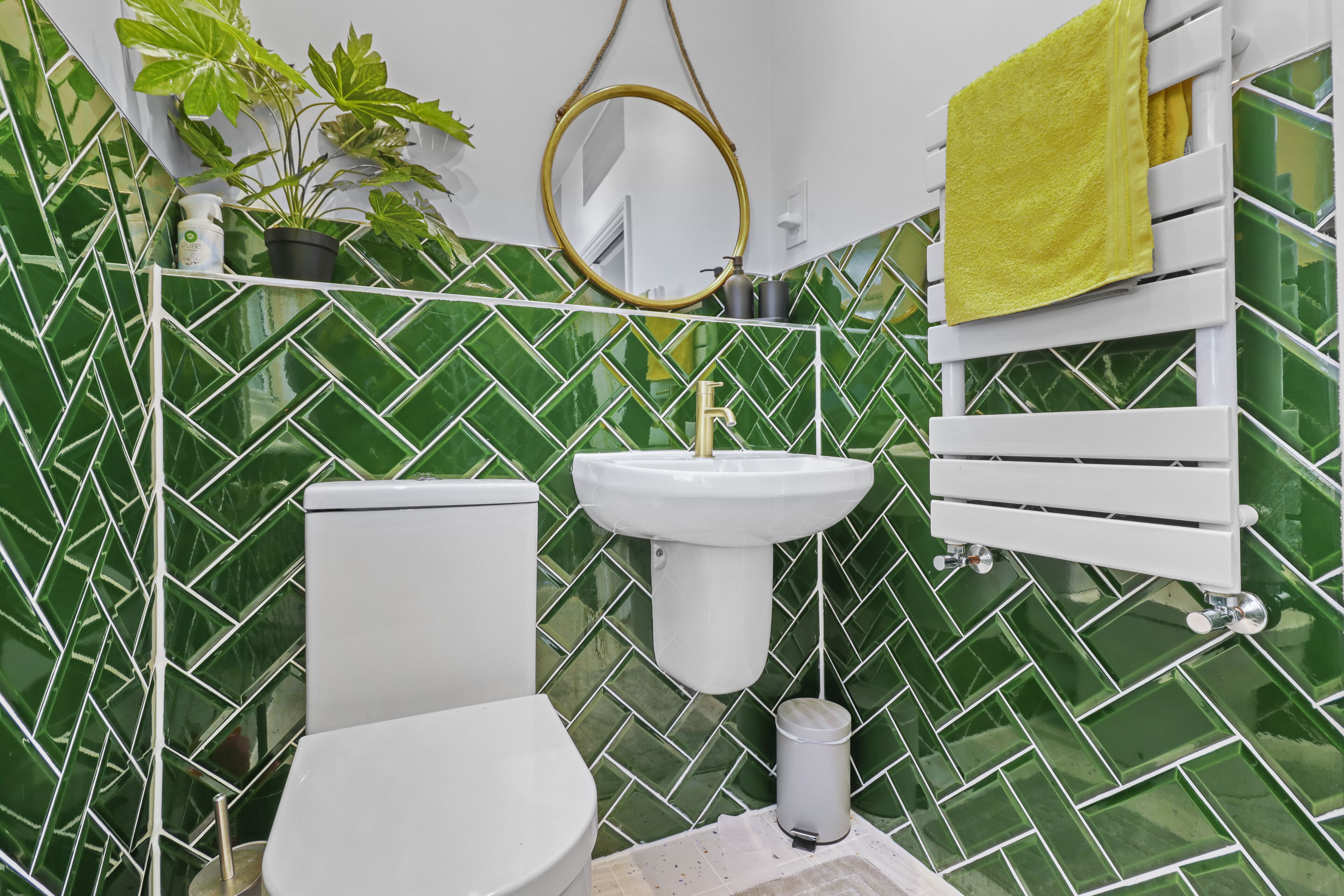 A bathroom with a white toilet, a white sink, and a mirror.