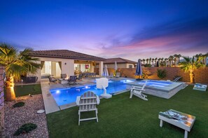 A backyard with a swimming pool, outdoor seating, and palm trees. - Private pool & hot tub w/ mountain views (La Quinta)