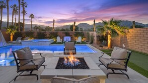 A backyard with a swimming pool, fire pit, and outdoor seating. - Signature View! Gorgeous BRAND NEW Home (Misters!) (La Quinta)