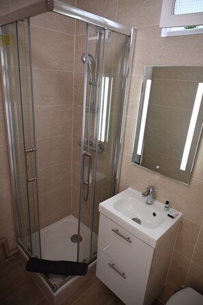 Shower, hair dryer, towels, soap