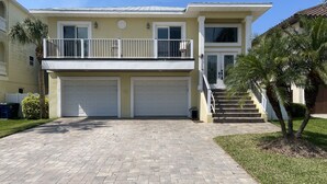 A two-story house with a covered driveway, a balcony, and a garage. - One block from Beach. Spacious 2 bedroom apartment BTR #2197 (Indian Rocks Beach)