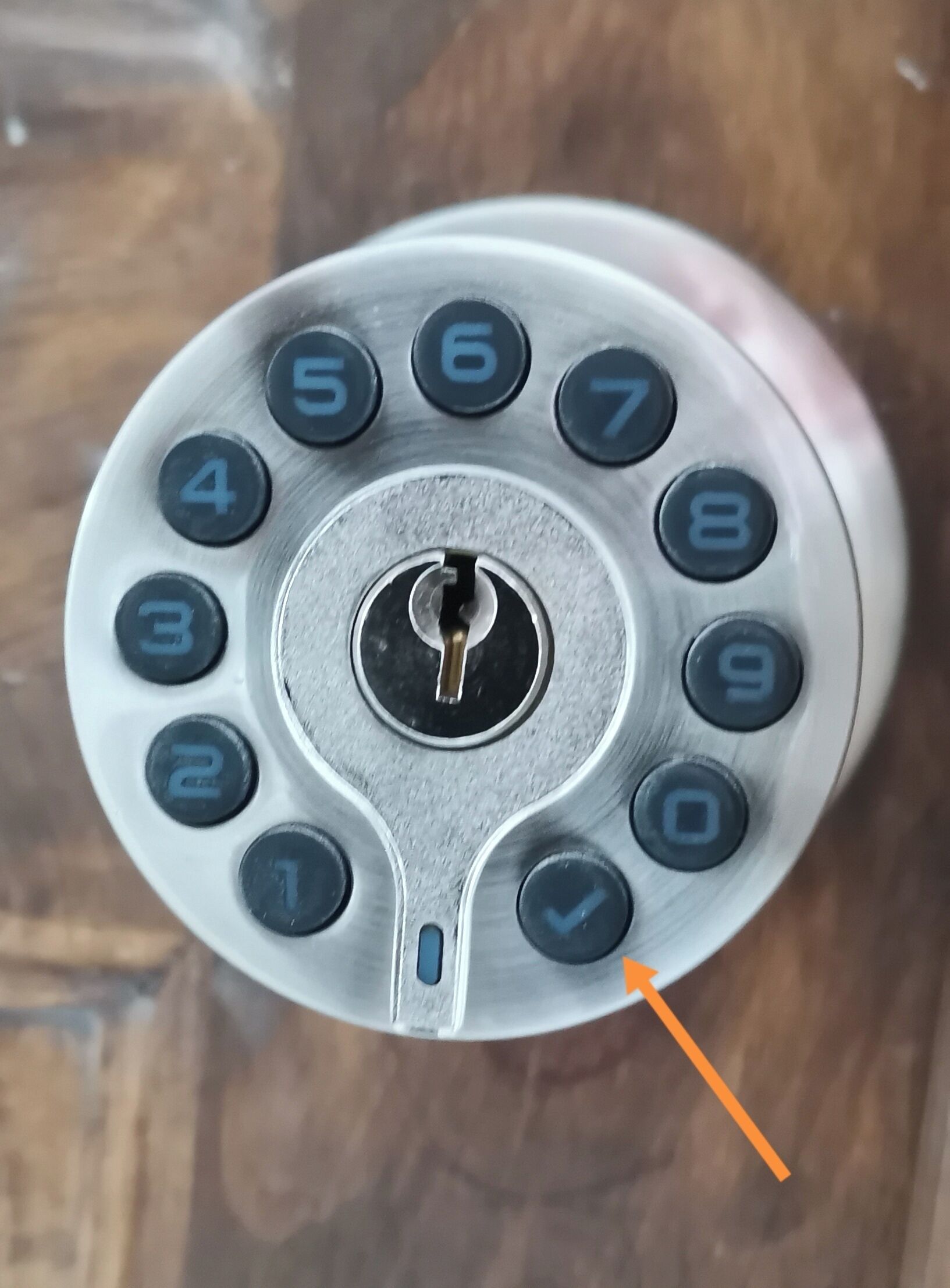 A close-up of a rotary dial telephone with a keyhole in the center.