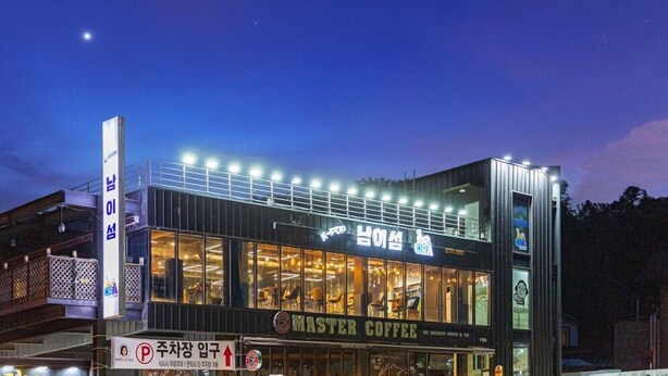 A building with a sign for 'Master Coffee' and a 'K-Pop' sign. - the allin pension (Gapyeong)