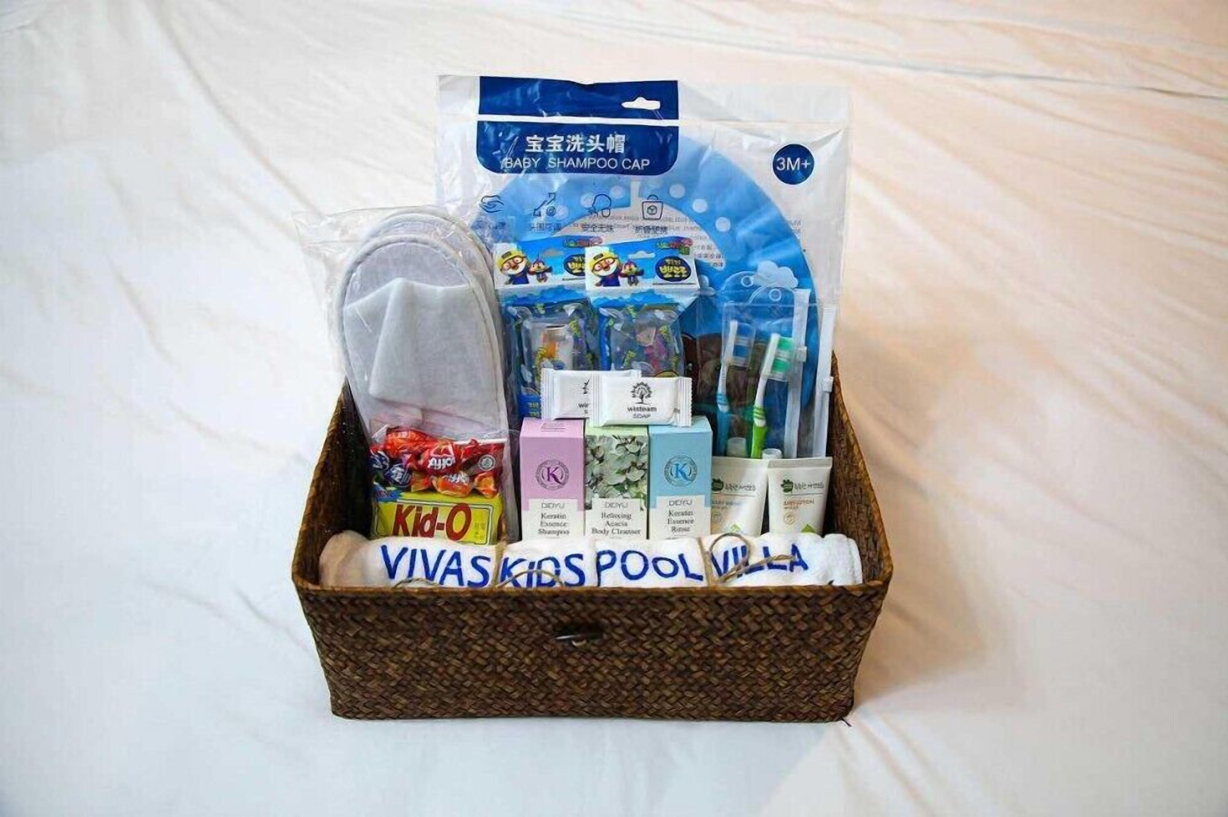 A gift basket containing baby shampoo, toys, and toiletries.