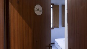 A wooden door with a sign that reads "Malvasa." - Chianti's Inn Malvasia (Firenze)