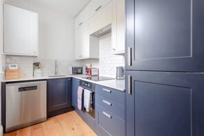 Enjoy cooking in this well-equipped kitchen with a dishwasher, oven, microwave, and toaster.
