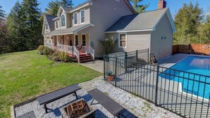 A two-story house with a covered porch, a swimming pool, and a fenced patio area. - Blueberry More Limit 17 7 Bedroom Home by RedAwning (Raymond)
