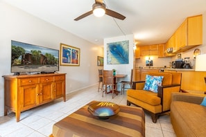 Relax in this inviting living space with a flat-screen TV, comfortable sofa, and dining area.