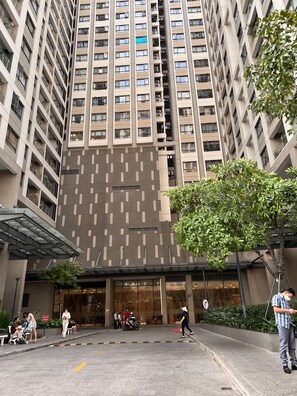 Un immeuble de grande hauteur doté d’une architecture moderne, caractérisé par une façade à motifs et de nombreux balcons.