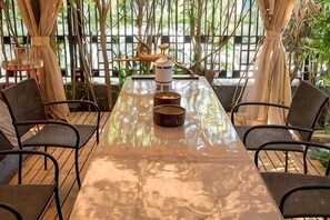 A long table with chairs, a kettle, and a teapot. - Shenmi Sidou Hostel (Nanjing)