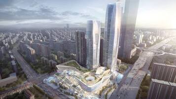 A high-rise building complex with multiple skyscrapers, a central plaza, and surrounding residential buildings.