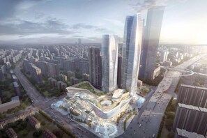 Un complejo de edificios de gran altura con varios rascacielos, una plaza central y edificios residenciales circundantes.