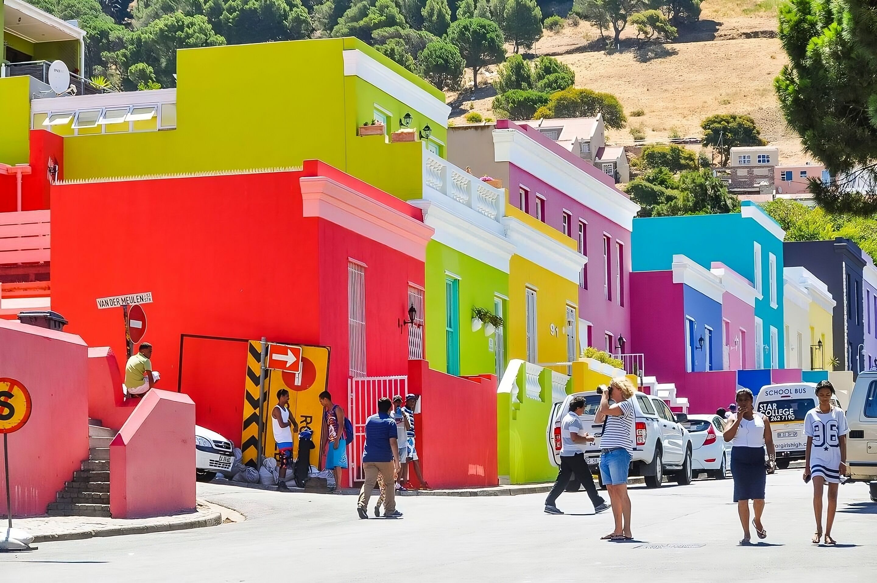 A colorful street with buildings painted in bright colors like red, green, and yellow.