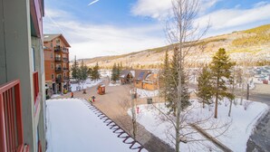 A snowy mountain town with buildings, a clear sky, and a snow-covered street. - Silver Mill 8220 (Keystone)