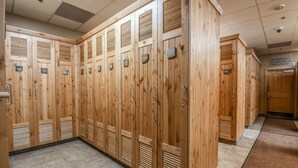 A row of wooden lockers with metal handles and numbered tags. - Silver Mill 8220 (Keystone)