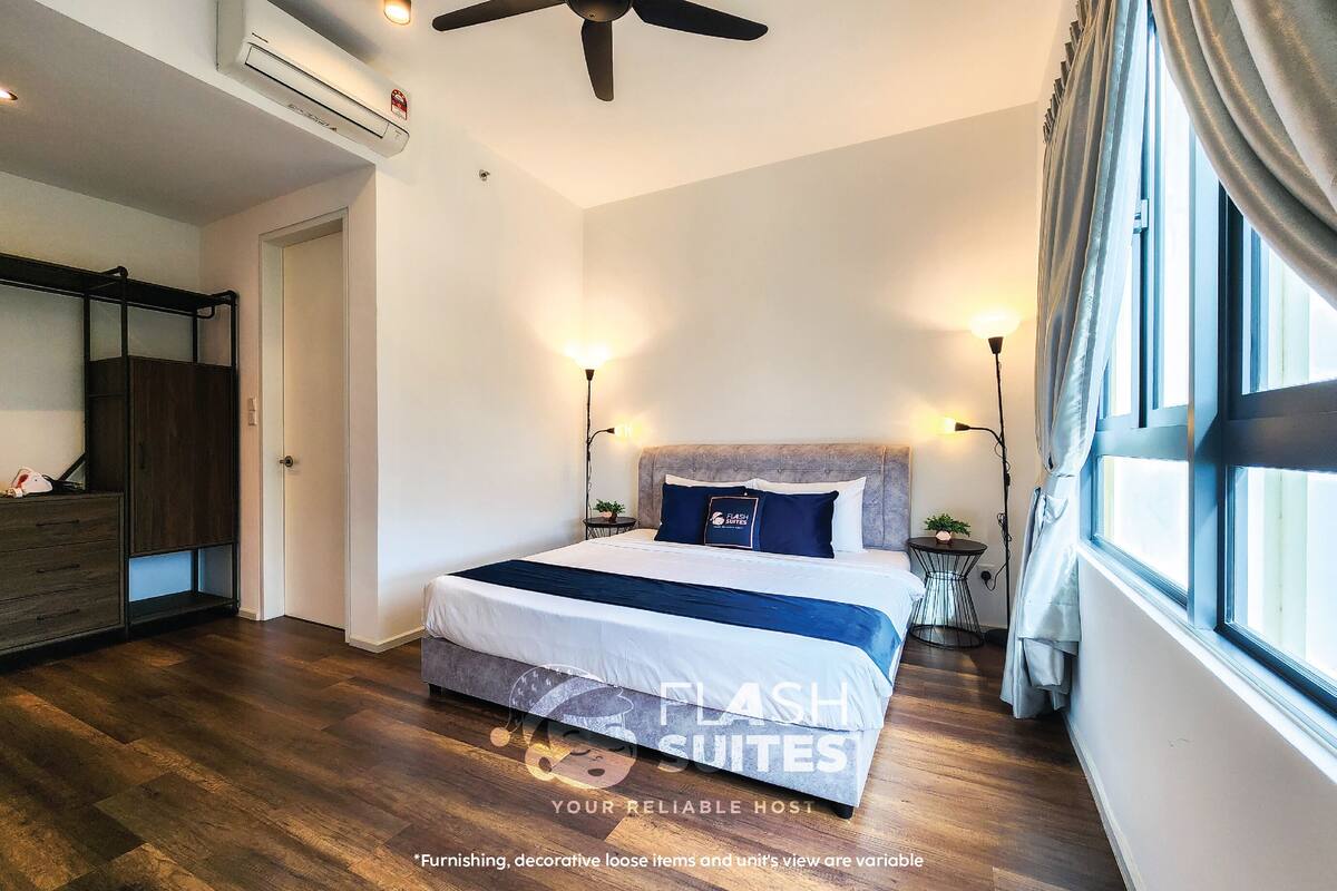 A bedroom with a bed, bedside tables, a ceiling fan, and a window with curtains.